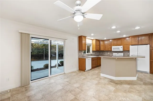 a view of kitchen with refrigerator and window