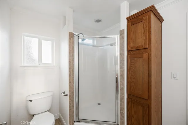 a bathroom with a toilet shower and a sink