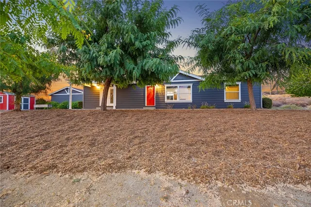 a house that has a tree in front of it
