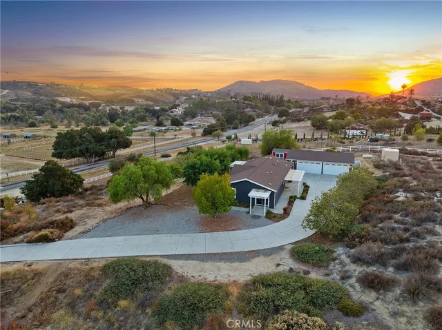 an aerial view of residential houses with outdoor space and street view