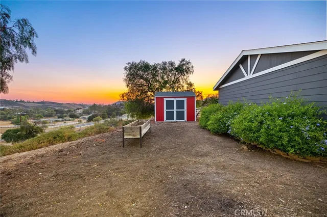 a view of a house with a yard and sitting area