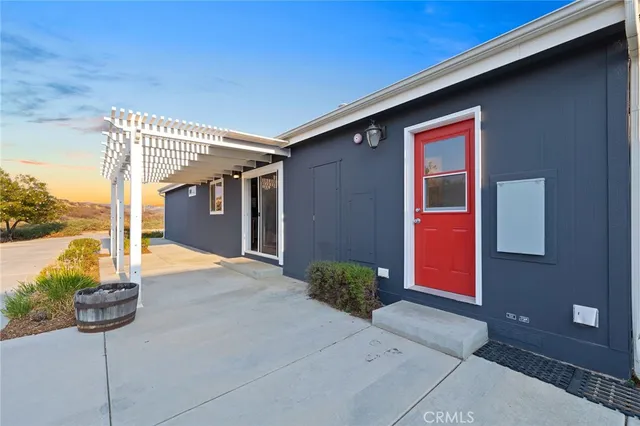 a view of a house with a yard and potted plants