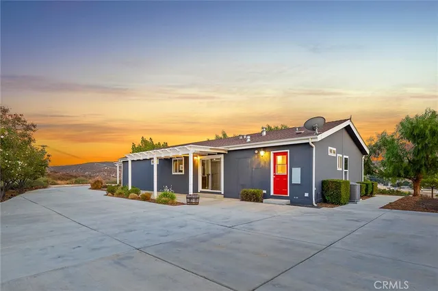 a view of roof with a small yard and a large tree