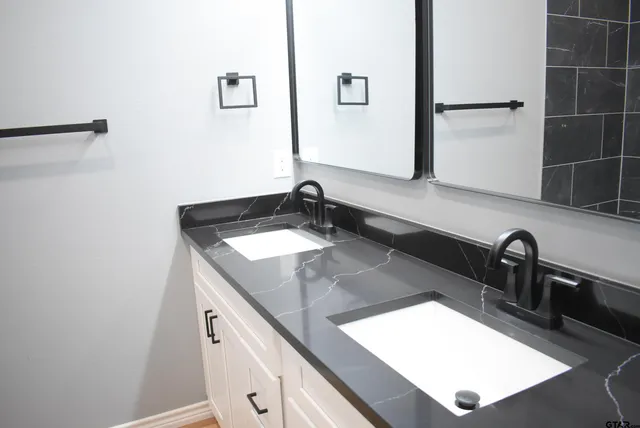 a bathroom with a sink and a mirror