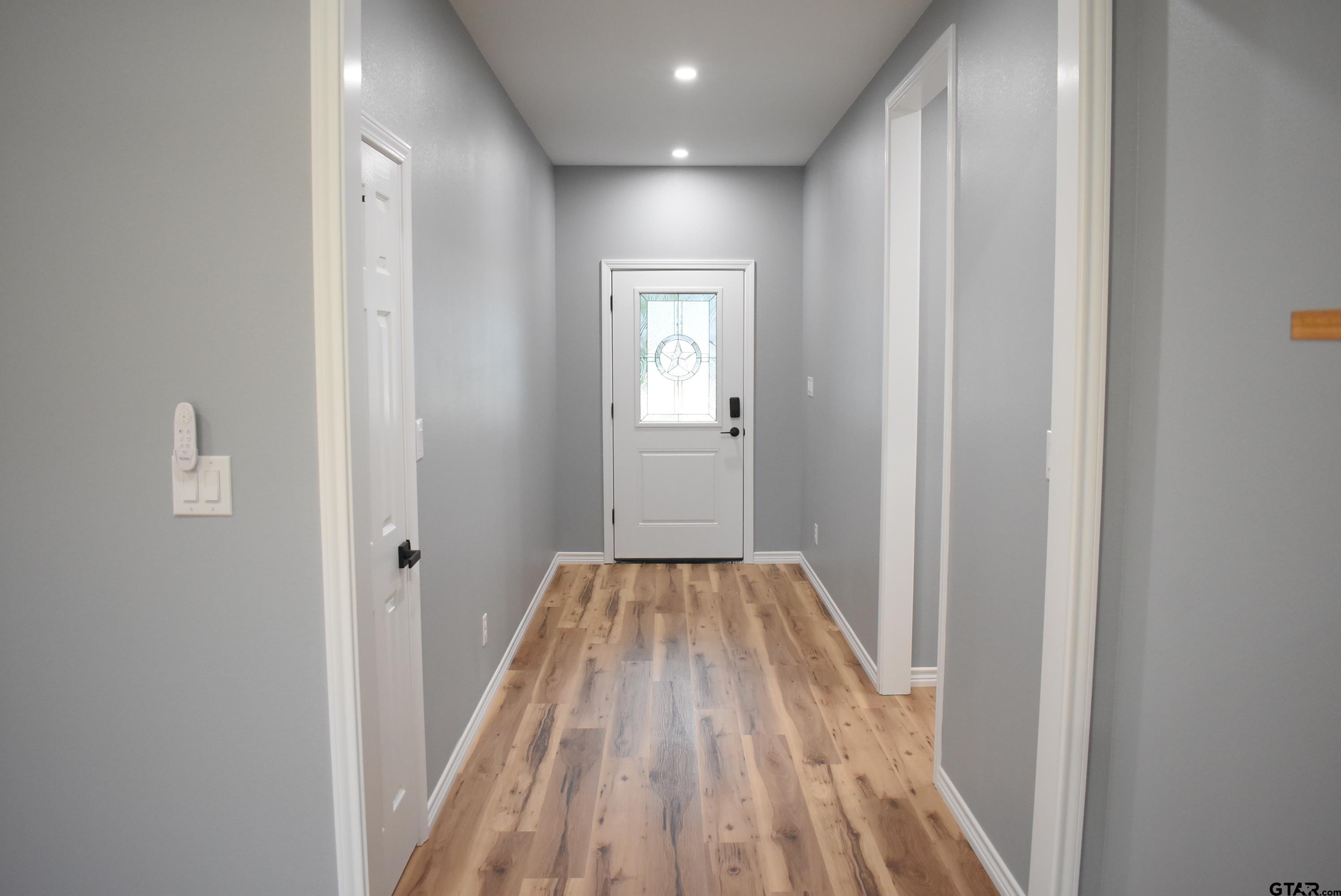 162 Ruby Lane Nacogdoches, TX 75965 - Photo 20 of 44 a view of a hallway with wooden floor and a bathroom