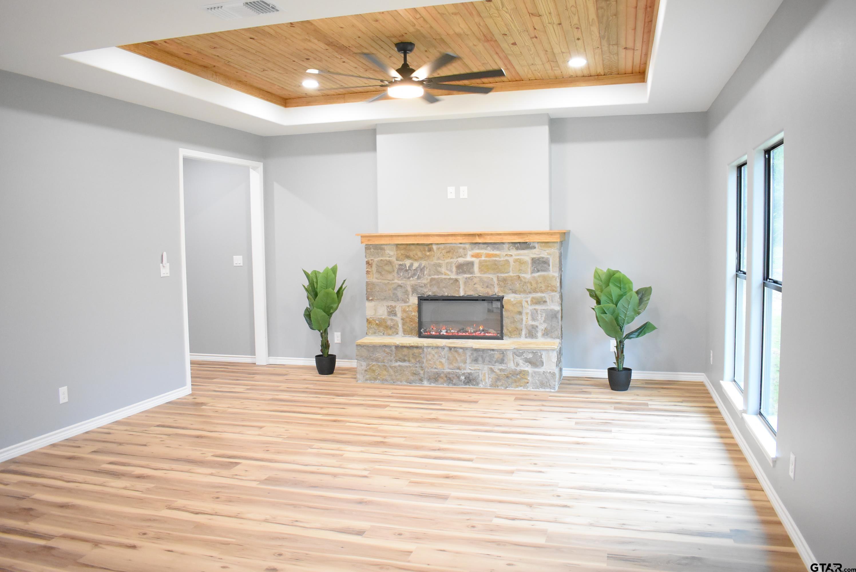162 Ruby Lane Nacogdoches, TX 75965 - Photo 2 of 44 a view of an empty room with wooden floor and a fireplace
