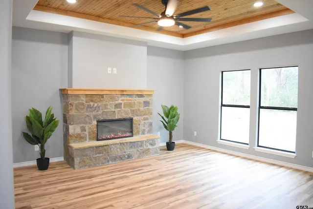 a living room with a fireplace and wooden floor