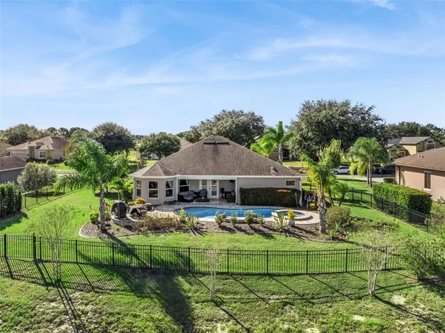 an aerial view of a house having swimming pool garden and patio