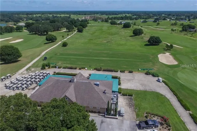 an aerial view of a house with outdoor space swimming pool