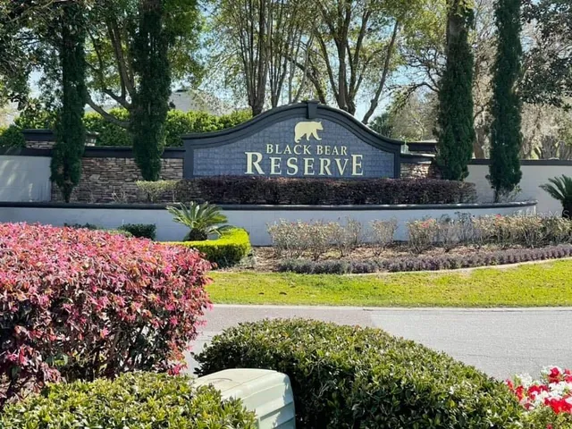 a front view of a house with a yard and fountain