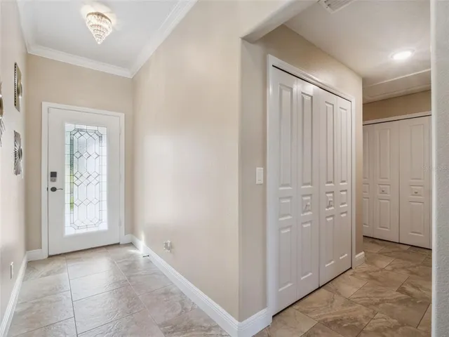an empty room with windows and closet