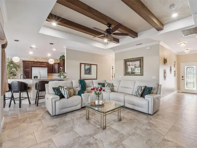 a living room with furniture and a chandelier
