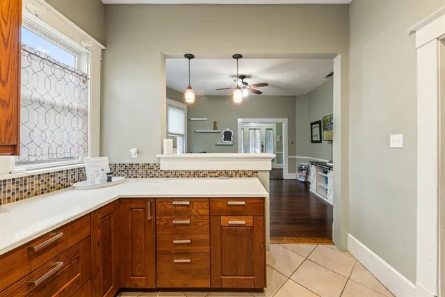 a view of a hallway with a dining table chairs and a chandelier