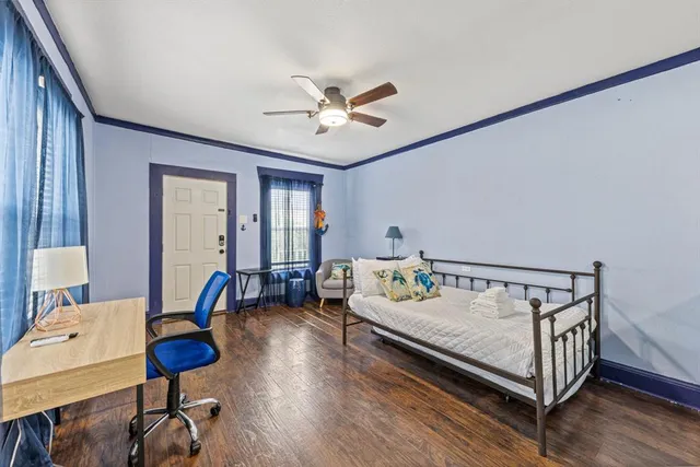 a bedroom with furniture and a wooden floor