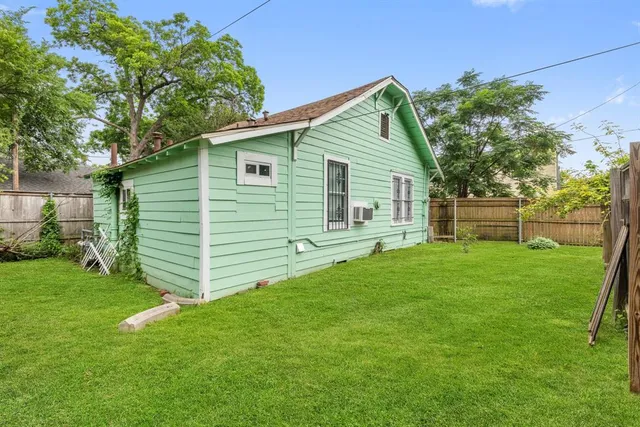 a view of a backyard with potted plants and large tree