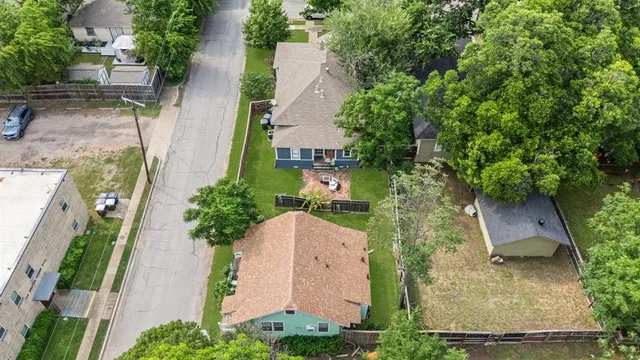 an aerial view of a house with garden space and street view