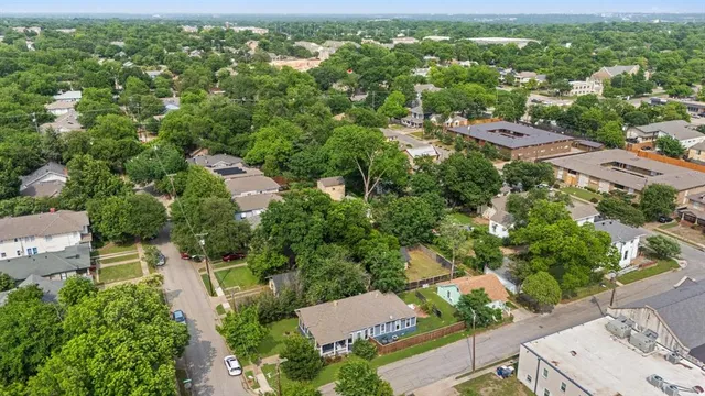 an aerial view of residential houses with outdoor space