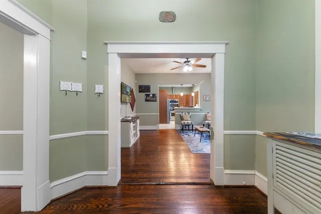 a view of living room with furniture and wooden floor