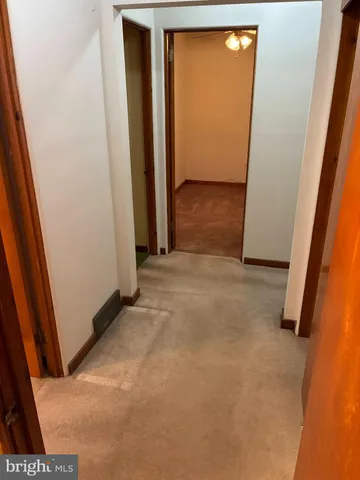 a view of an empty room with wooden door