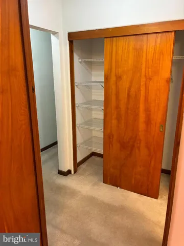 a view of a brick wall with water heater and a sink