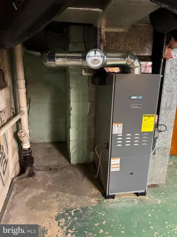 a view of a room with wooden floor and a window