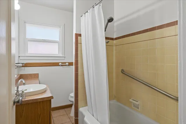 a bathroom with a shower and a sink