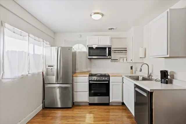 a kitchen with stainless steel appliances a refrigerator stove and sink