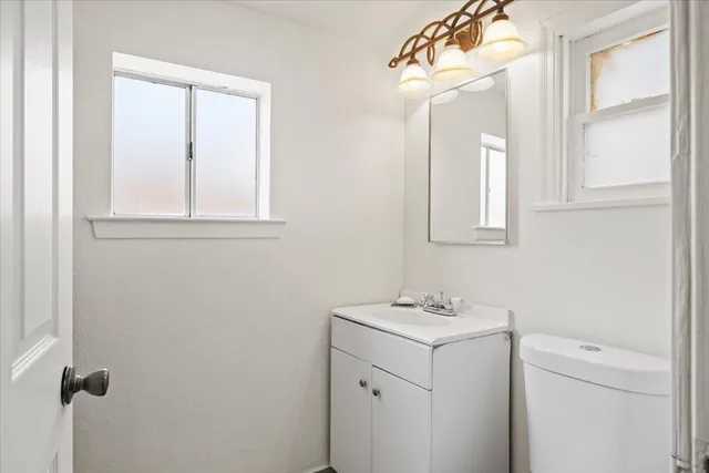 a bathroom with a sink a vanity and a mirror