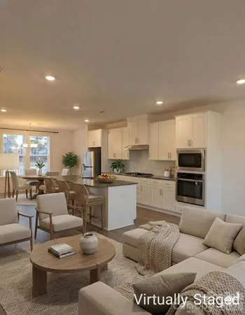 a living room with furniture kitchen and a kitchen view