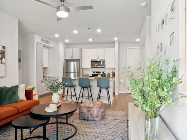 a living room with furniture potted plant and a chandelier