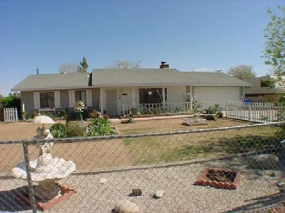 13009 Clallam Road Apple Valley, CA 92308 - Photo 1 of 1 a front view of a house with garden