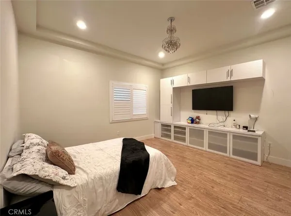 a living room with furniture kitchen and a wooden floor