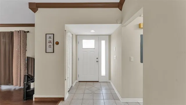 a view of a hallway with wooden floor and closet