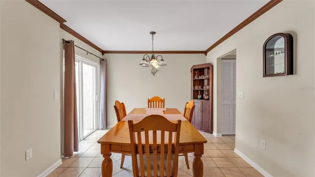 a view of a dining room with furniture and chandelier