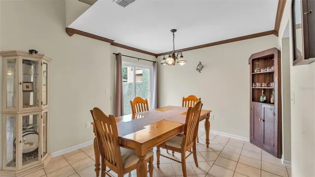 a dining room with furniture and chandelier