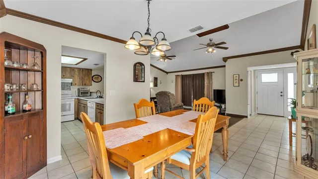 a view of a dining room with furniture and a chandelier