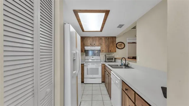 a kitchen with stainless steel appliances granite countertop a sink and a stove
