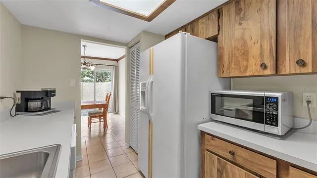 a kitchen with a refrigerator and a table