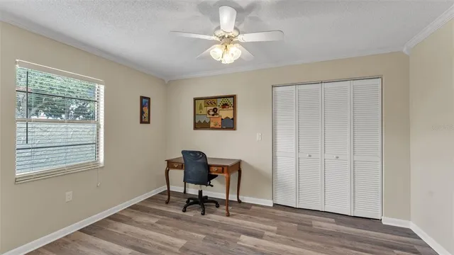 a workspace with wooden floor and a window