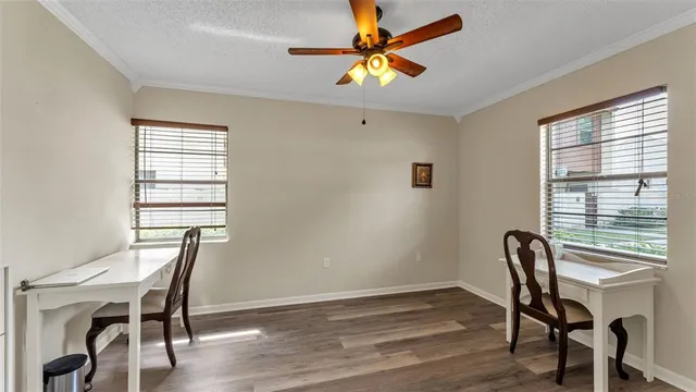 a view of a workspace with furniture and a window