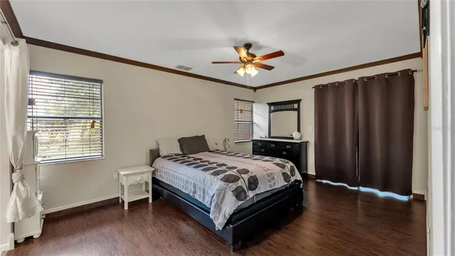 a bedroom with a bed dresser and a window