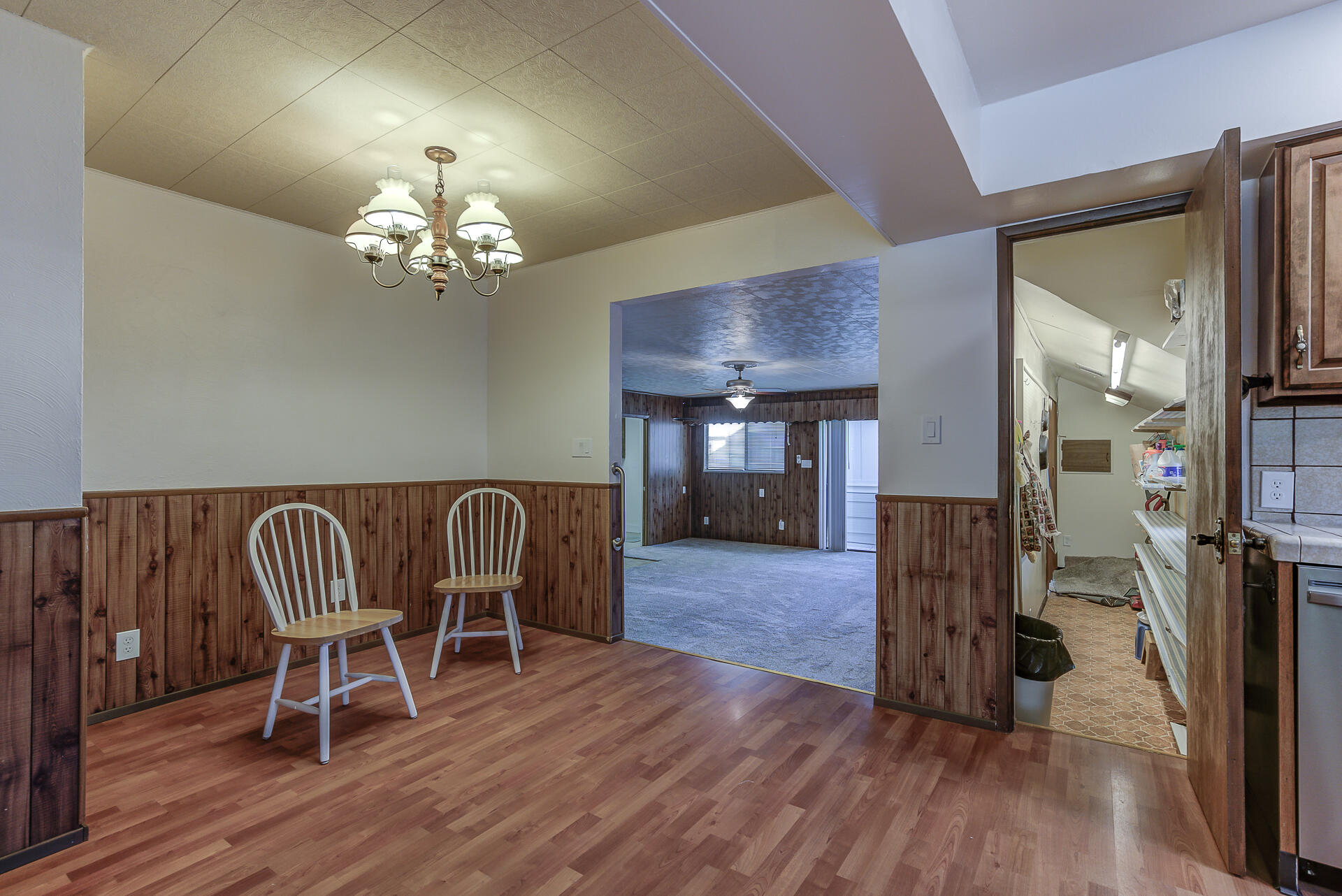 1445 Miller Way Red Bluff, CA 96080 - Photo 11 of 34 a view of a dining room with furniture wooden floor and chandelier