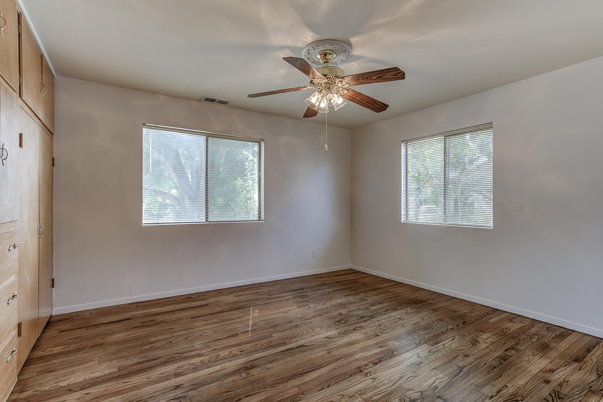 1445 Miller Way Red Bluff, CA 96080 - Photo 15 of 34 a view of an empty room with wooden floor and a window