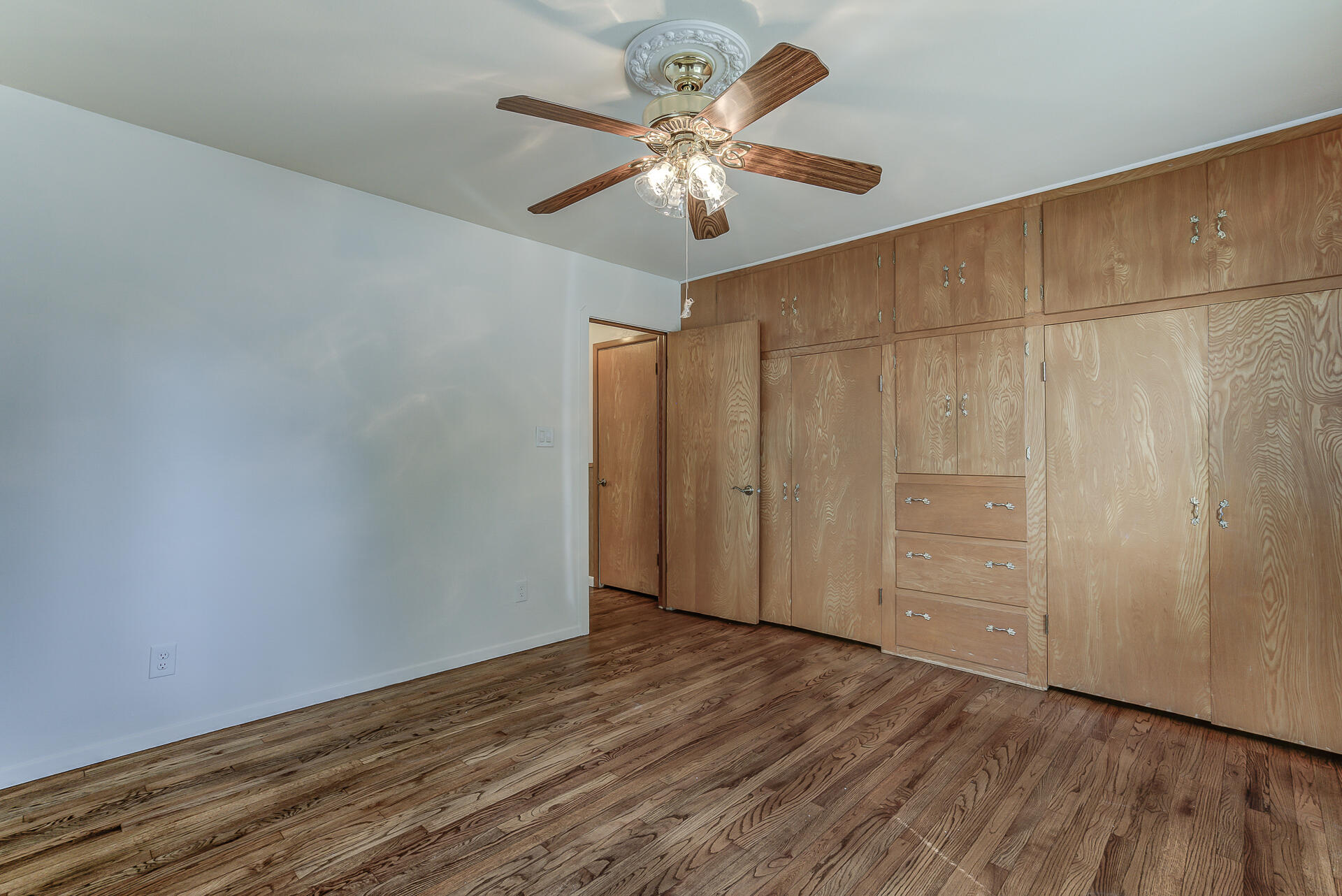 1445 Miller Way Red Bluff, CA 96080 - Photo 16 of 34 an empty room with wooden floor fan and windows