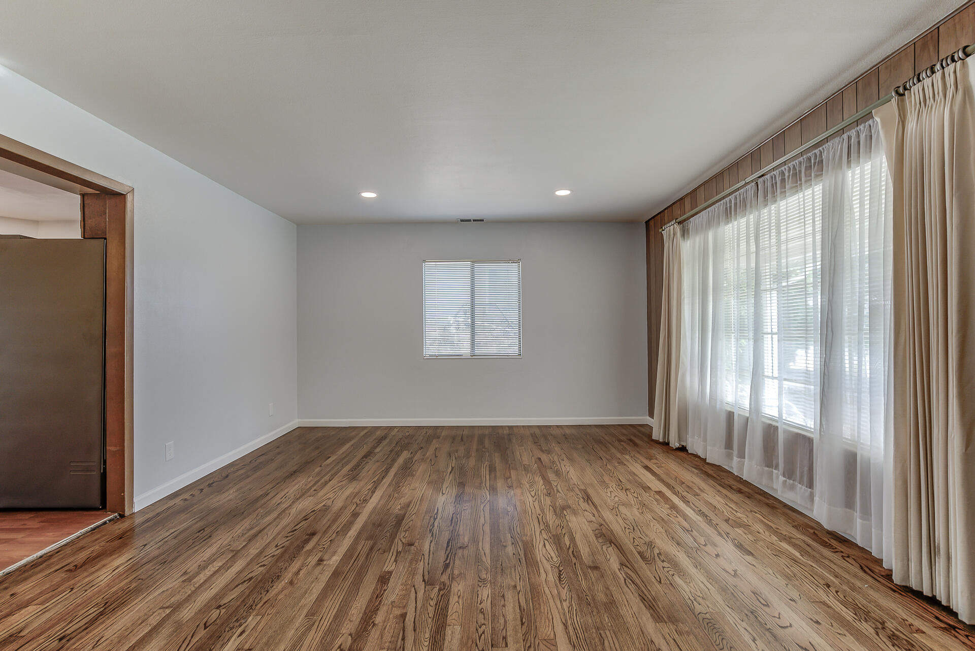 1445 Miller Way Red Bluff, CA 96080 - Photo 5 of 34 wooden floor in an empty room with a window