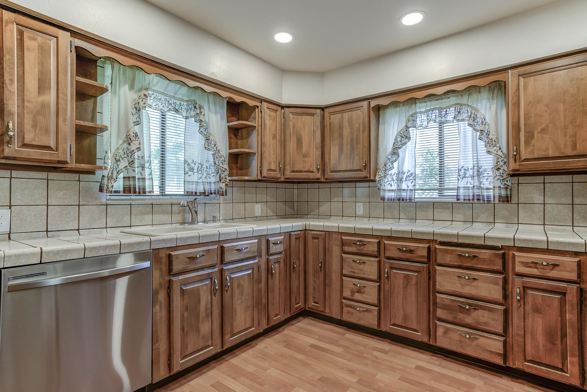 1445 Miller Way Red Bluff, CA 96080 - Photo 9 of 34 a kitchen with stainless steel appliances granite countertop a sink and cabinets with wooden floor
