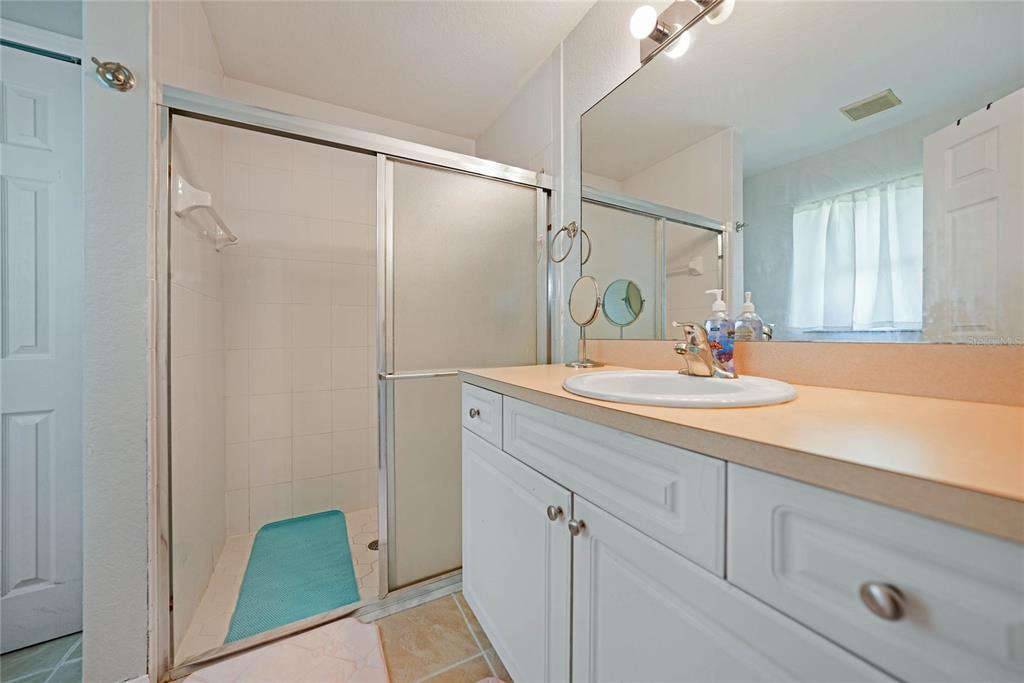 590 Ridgewood Street Northwest Port Charlotte, FL 33952 - Photo 18 of 32 a bathroom with a sink and a mirror