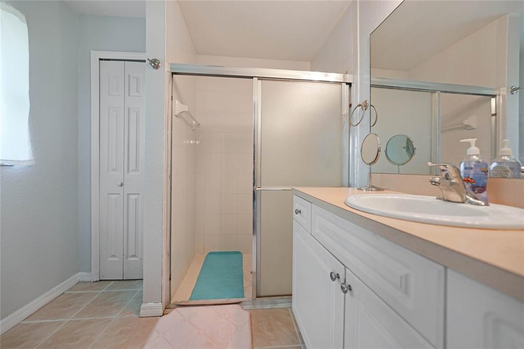 590 Ridgewood Street Northwest Port Charlotte, FL 33952 - Photo 19 of 32 a bathroom with a sink and a mirror