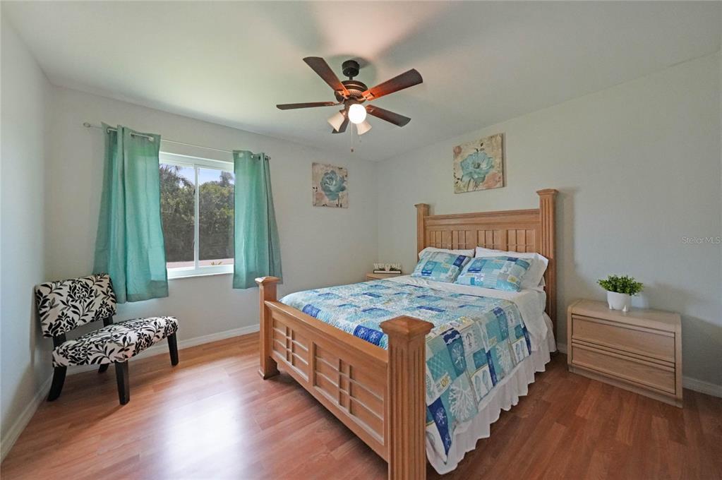 590 Ridgewood Street Northwest Port Charlotte, FL 33952 - Photo 20 of 32 a bedroom with a bed and windows