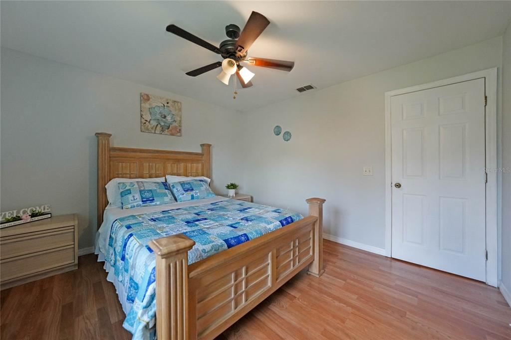 590 Ridgewood Street Northwest Port Charlotte, FL 33952 - Photo 21 of 32 a bed sitting in a bedroom next to a window
